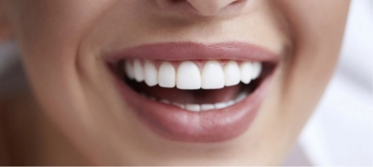 A close-up of a smiling woman's mouth.