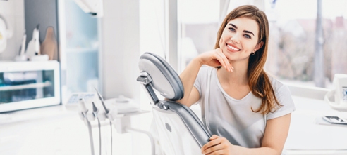 A smiling woman sits in a dental chair at Northern Peaks Dental, highlighting their new patients dental specials in Sandpoint, Idaho.