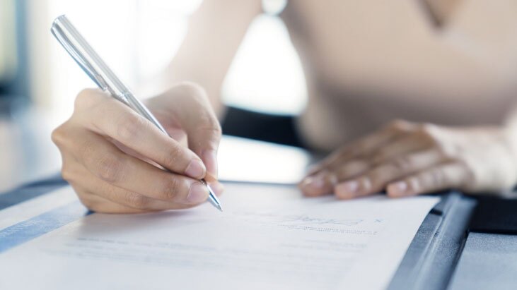 A patient sitting and filling out form