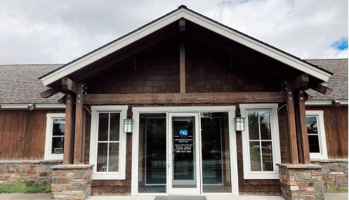 Front view of Northern Peaks Dental, a rustic building in Sandpoint, ID, offering dental services.