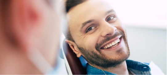 happy-smiling-young-man-in-dental-chair-at-Northern-Peaks-Dental